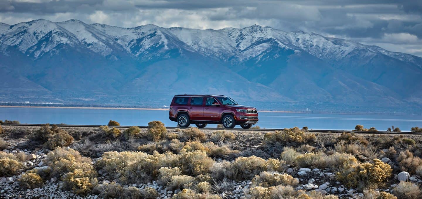 Display The 2022 Wagoneer parked against a magnificent mountain backdrop.