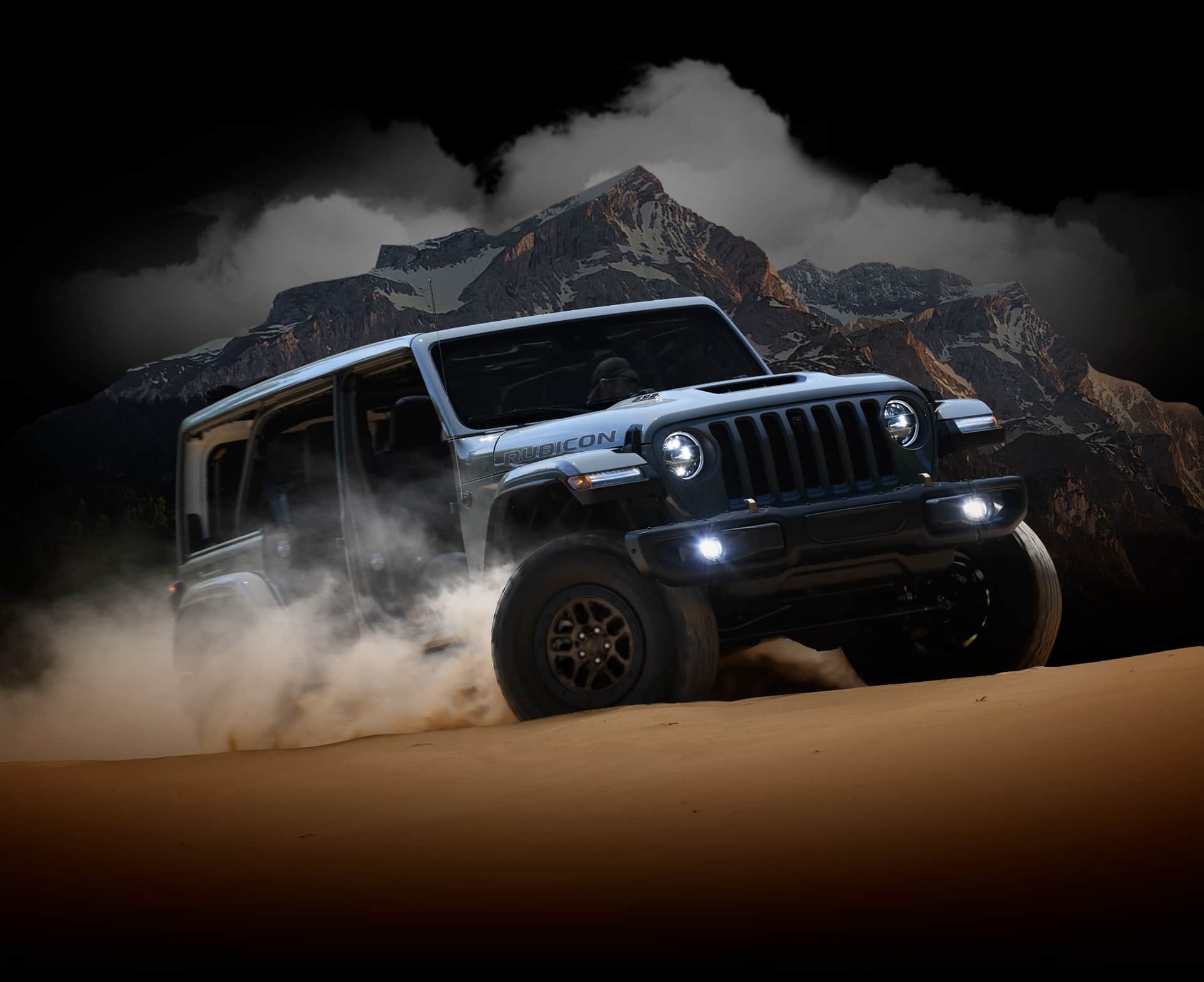 The 2022 Jeep Wrangler Rubicon 392 with its doors off and outfitted with the Xtreme Recon Package, straddling a split in a rock.