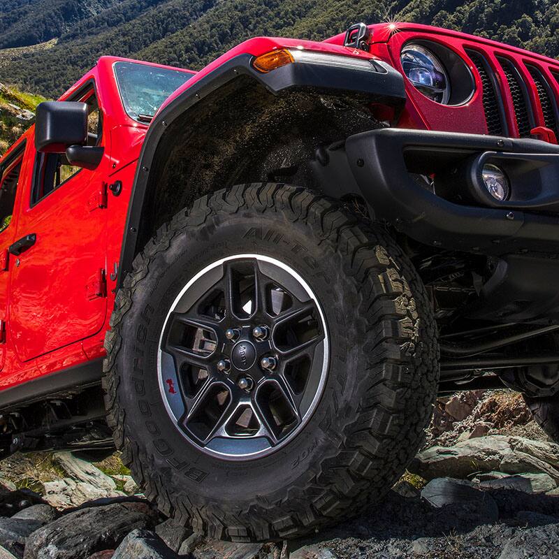 An extreme close-up of the passenger-side front wheel and tire on the 2022 Jeep Wrangler Rubicon.
