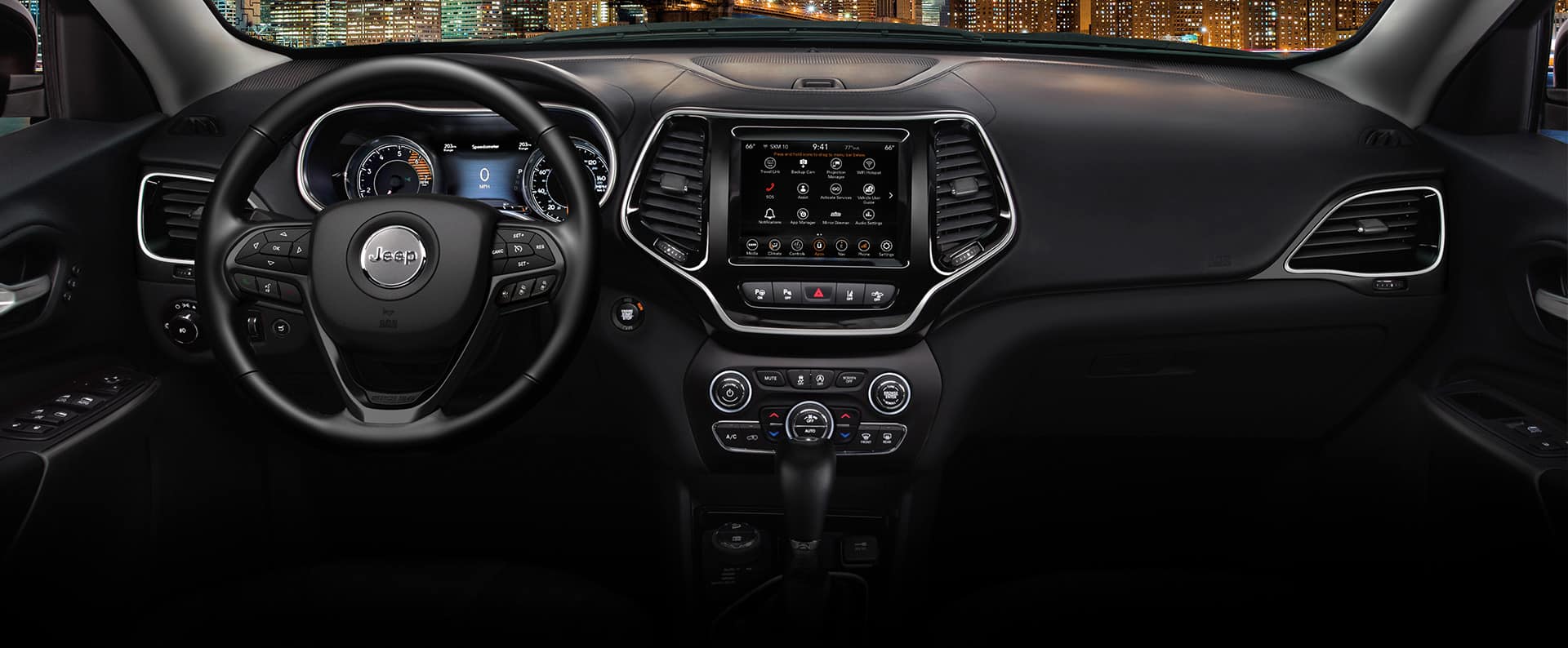 The interior of the 2023 Jeep Cherokee Altitude Lux focusing on the steering wheel, Digital Cluster Display, Uconnect touchscreen and center stack controls.