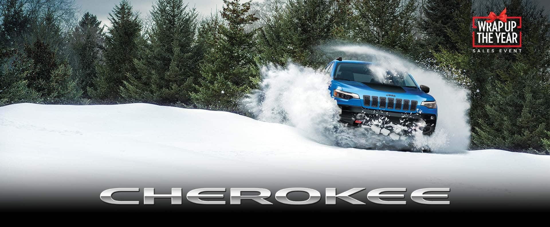 Un Jeep Cherokee Trailhawk 2023 azul levantando polvo blanco mientras surca nieve profunda. Evento de ventas de Black Friday. Cherokee.