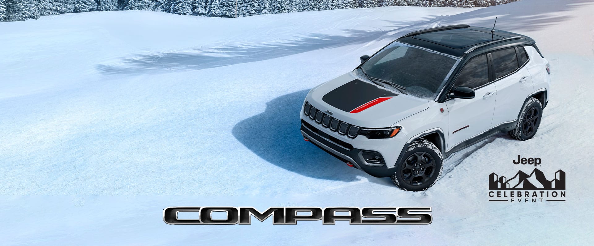 A 2023 Jeep Compass Trailhawk being driven down a snow-covered hill, off-road