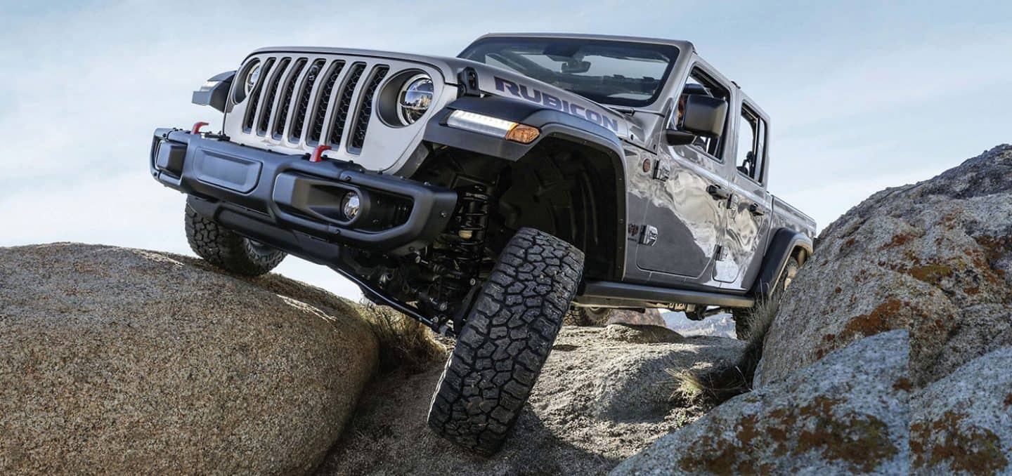 New 2023 Jeep Gladiator driving over a rocky outcrop