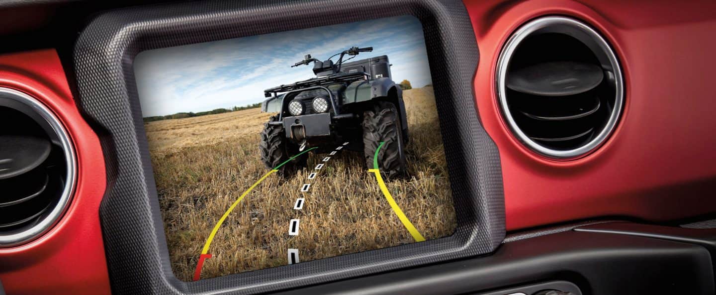 A close-up of the Uconnect touchscreen in the 2023 Jeep Gladiator Rubicon, displaying what is behind it.