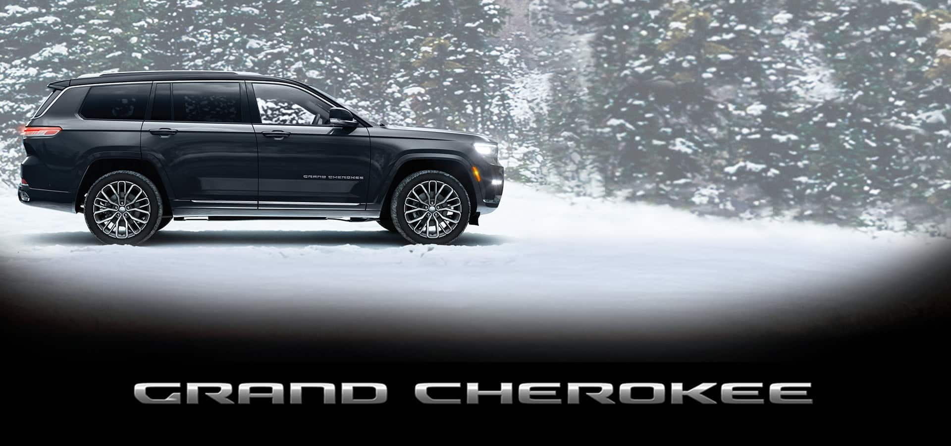 A profile of a 2023 Jeep Grand Cherokee L Summit Reserve parked on snow beside a forest. Grand Cherokee. 