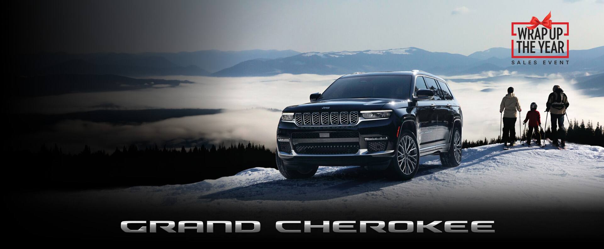  A black 2023 Jeep Grand Cherokee Summit Reserve parked on a snow-covered hill with a family of three standing nearby, ready to ski down the hill. The Wrap Up The Year Event. Grand Cherokee.