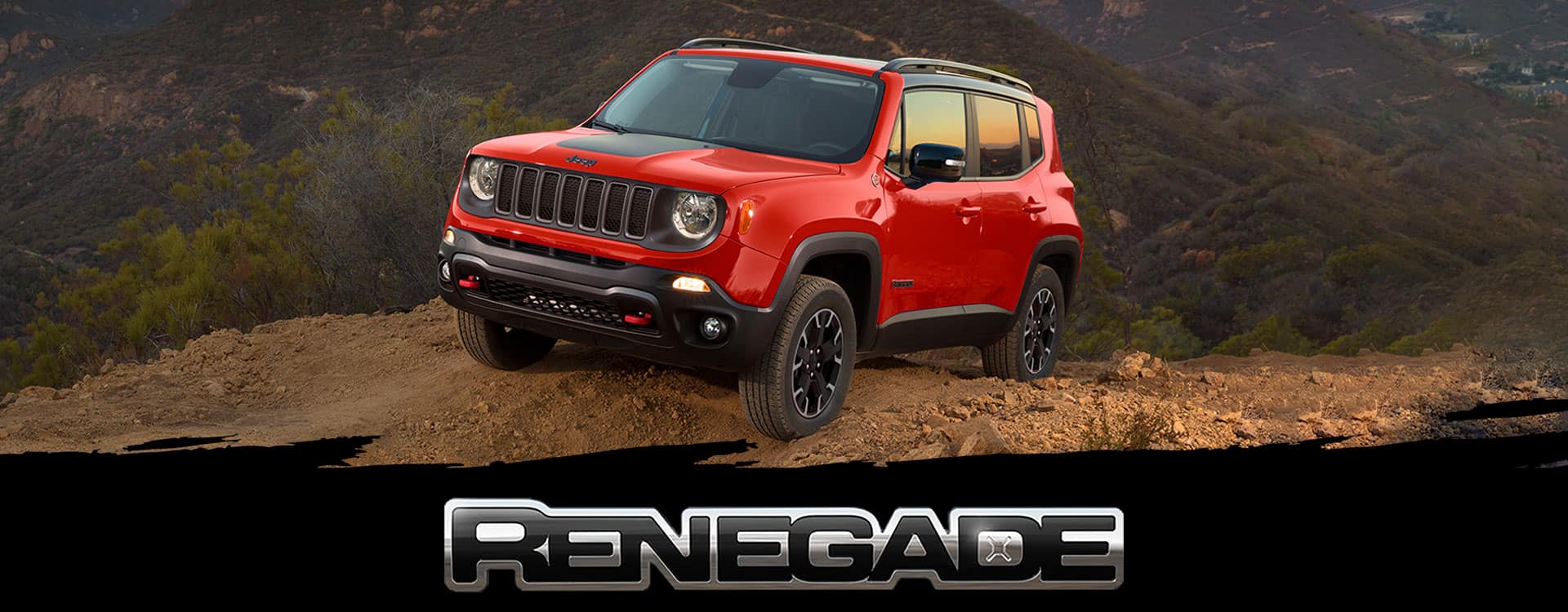 Renegade. A red 2023 Jeep Renegade Trailhawk parked on bare earth at the top of a hill.