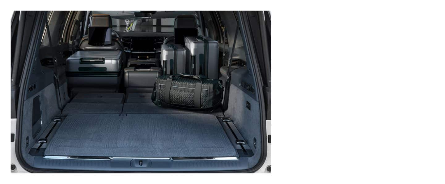 The cargo area of the 2023 Grand Wagoneer with the second and third rows folded and several suitcases in the hold.