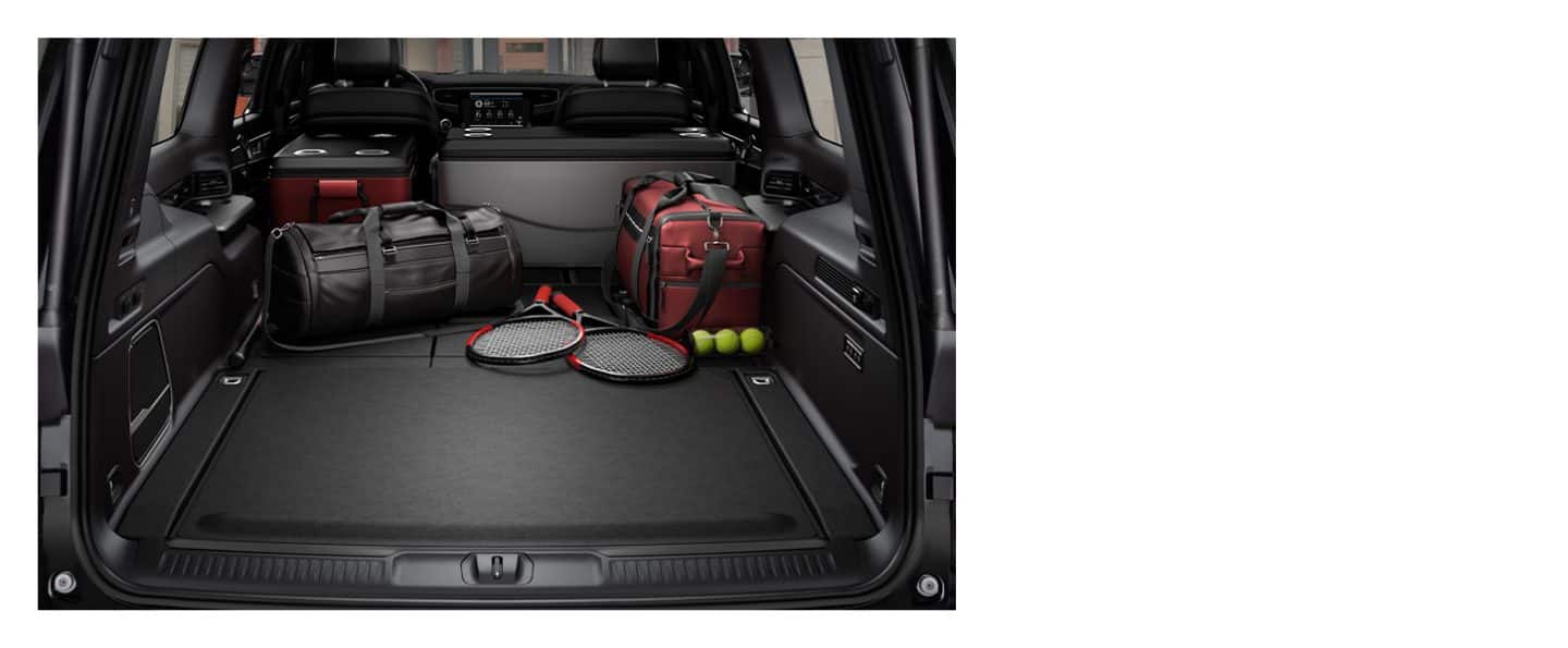 The cargo area of the 2023 Wagoneer with all the rear seats folded to fit coolers, duffel bags and tennis rackets.