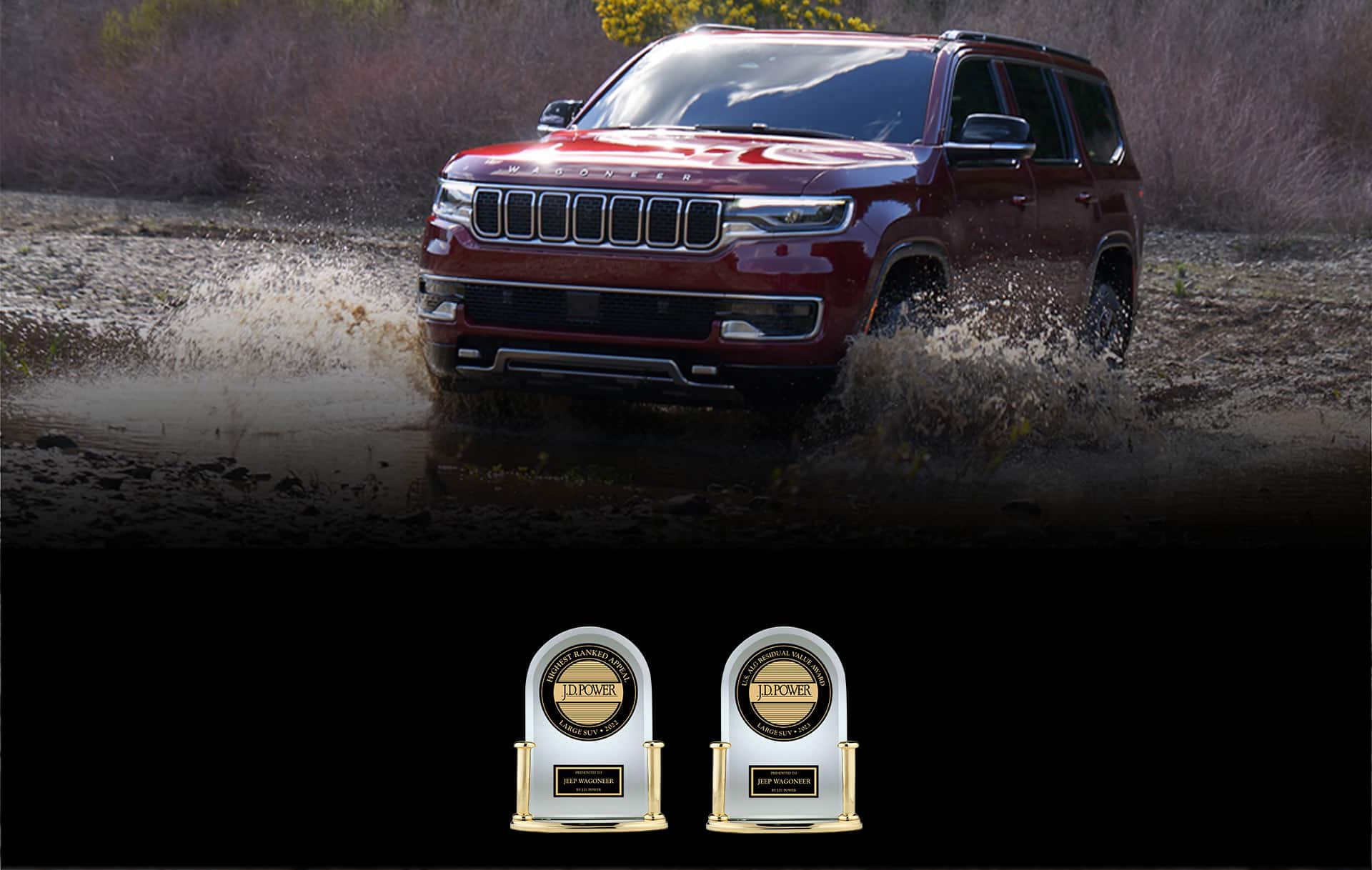 A red 2023 Wagoneer fording through a large stream. In the foreground two awards: the J.D.Power Highest Ranked Appeal—Large SUV 2022—presented to Jeep Wagoneer by J.D. Power and J.D. Power U.S. ALG Residual Value Award—Large SUV—2023 presented to Jeep Wagoneer by J.D. Power.