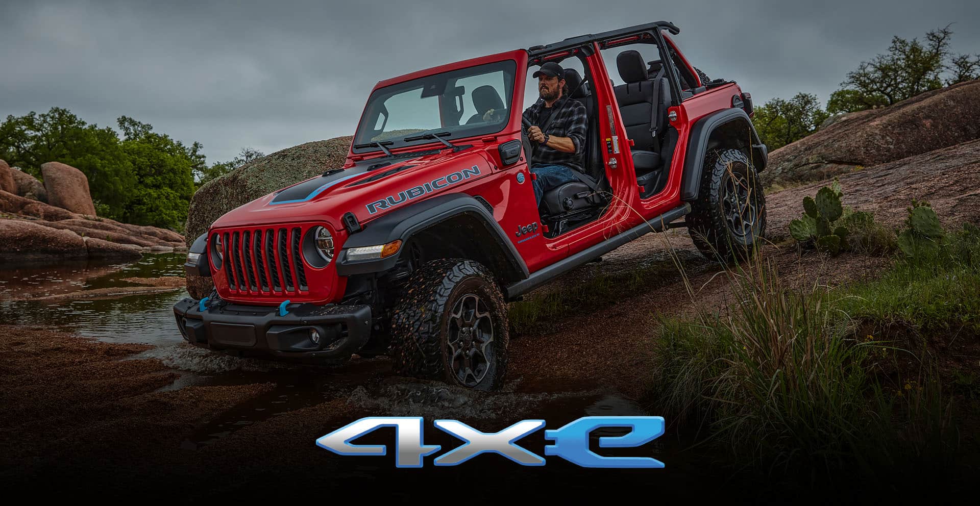 4xe. The 2023 Jeep Wrangler Rubicon 4xe with its top and doors off, being driven downhill into a stream.