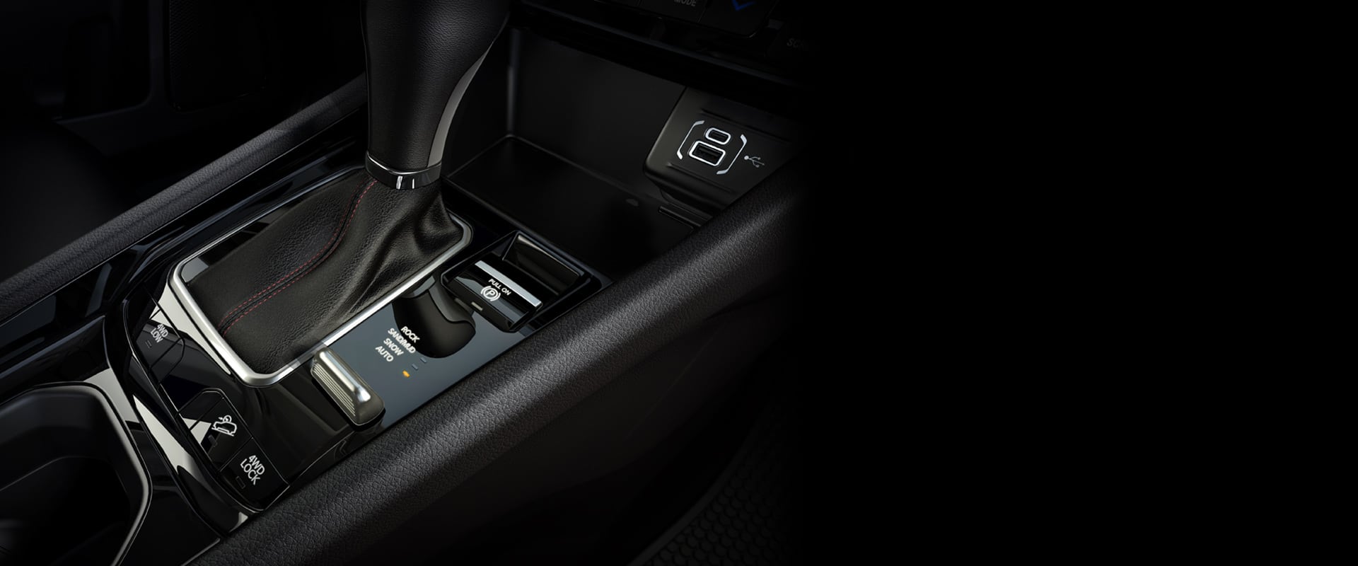  The center console in the 2024 Jeep Compass Trailhawk including the shifter, Selec-Terrain Traction Management System dial and wireless charging pad.