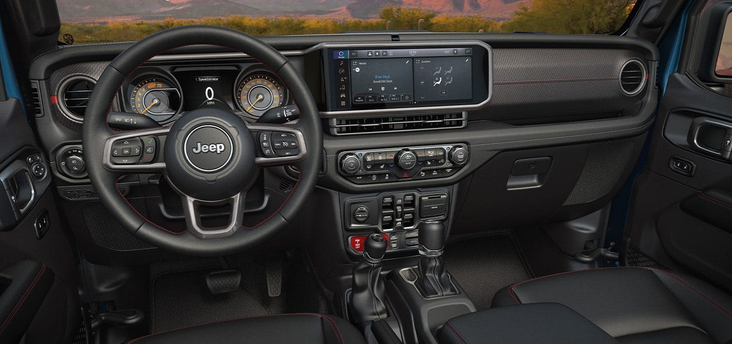 Display The steering wheel, Driver Information Digital Cluster, Uconnect touchscreen and center stack controls in the 2024 Jeep Gladiator.