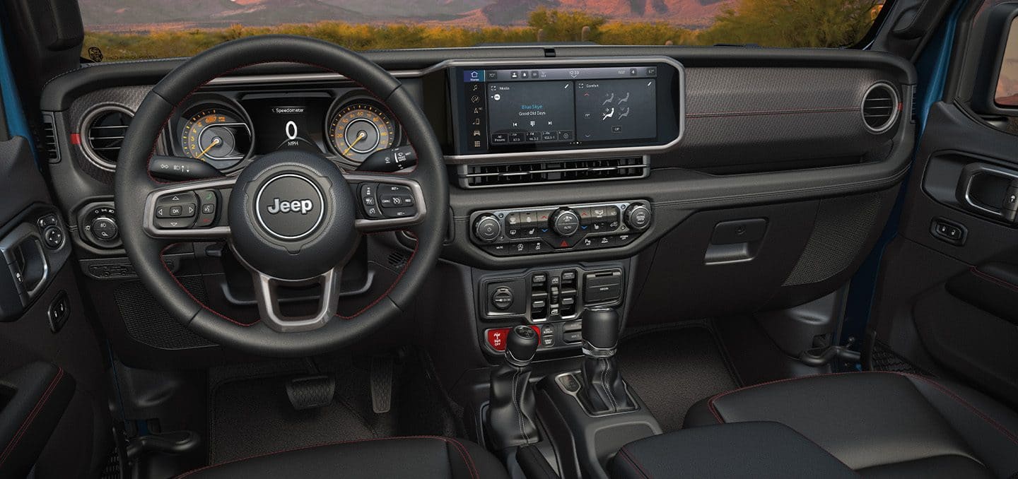Display The steering wheel, Driver Information Digital Cluster, Uconnect touchscreen and center stack controls in the 2024 Jeep Gladiator.