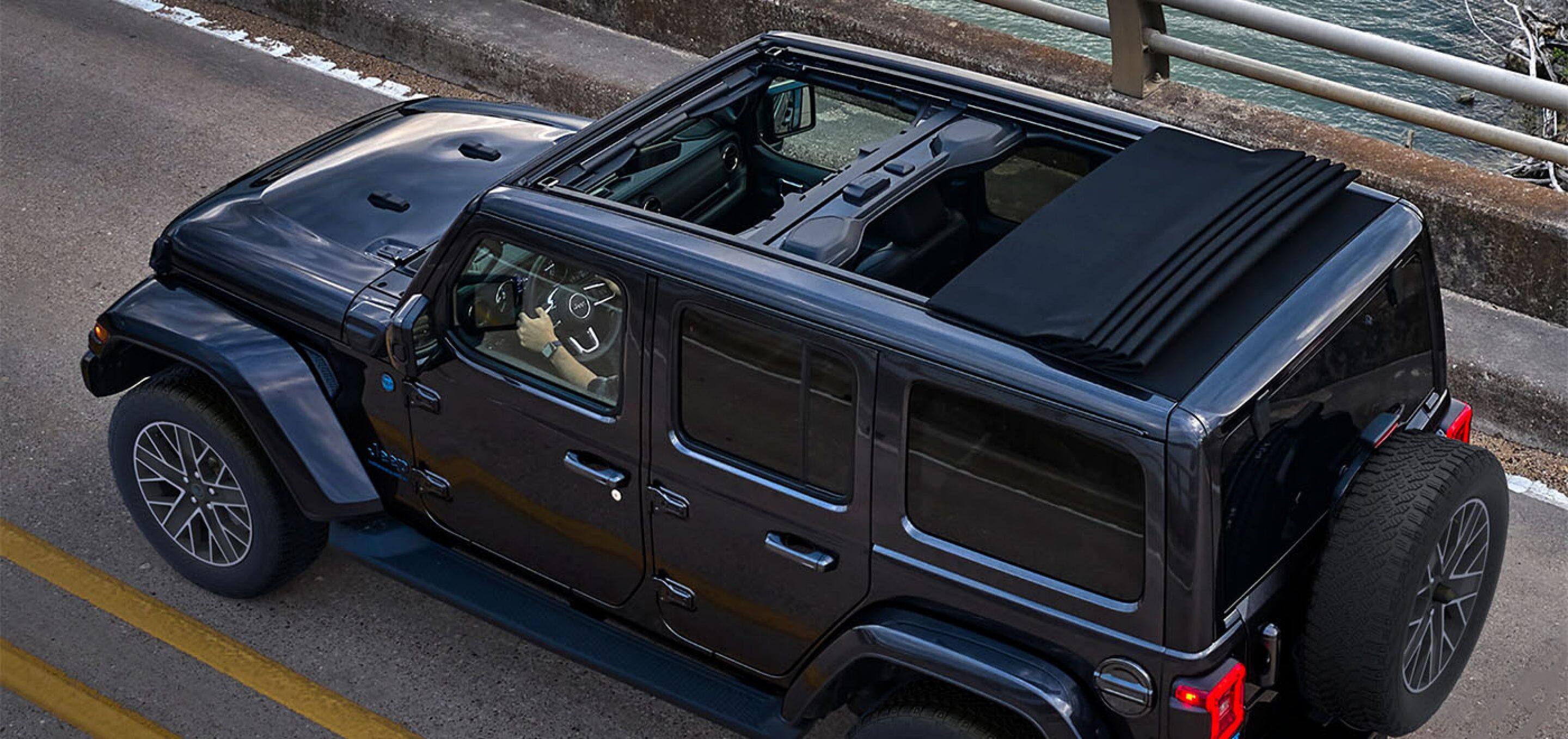 Top view of a Jeep Wrangler as it drives on the road. 