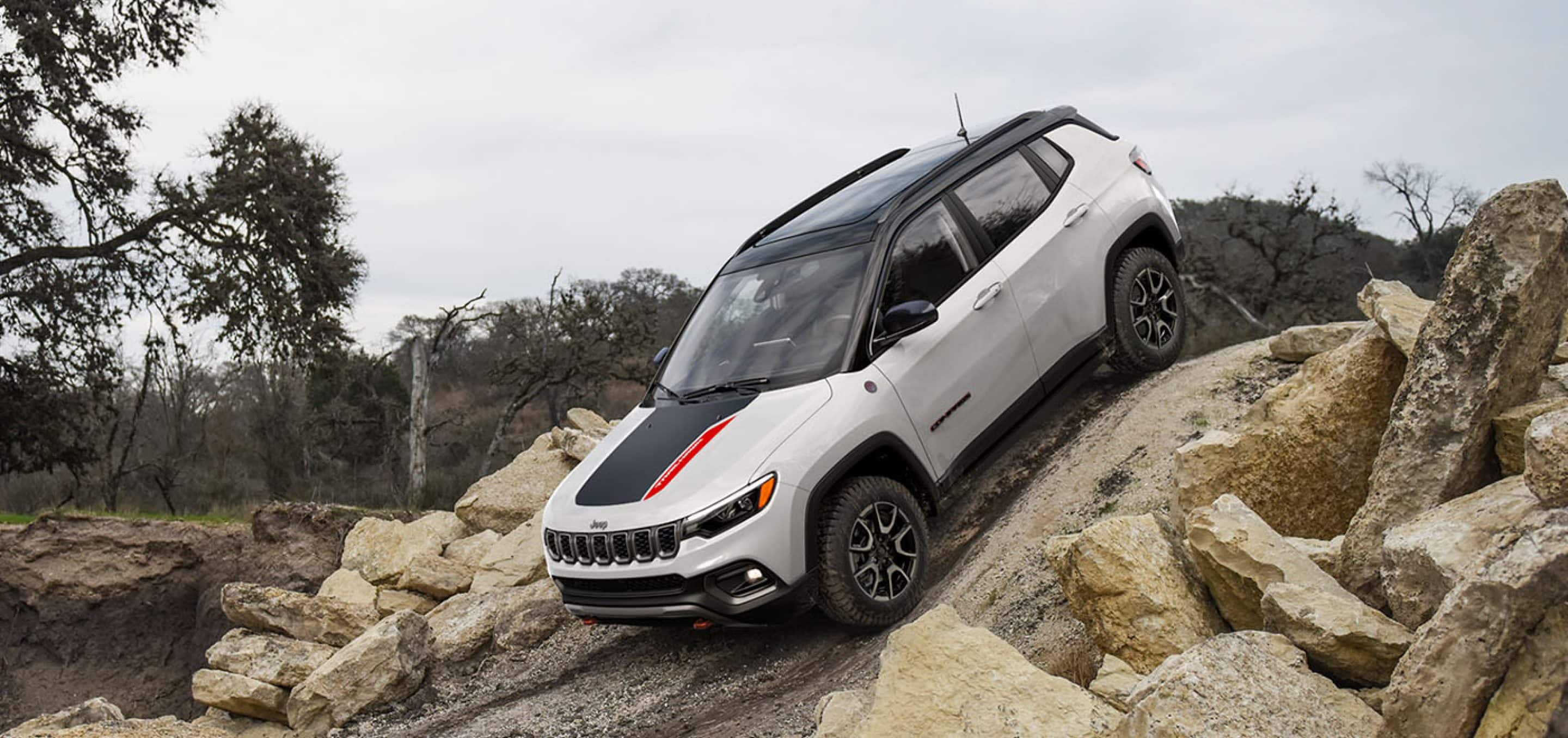 2025 Jeep Compass Trailhawk in white rock crawling a steep rocky trail