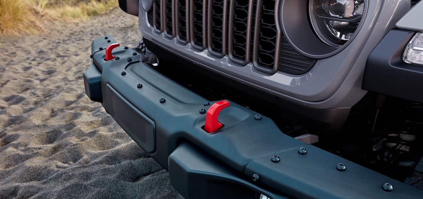 Display The red tow hooks on the front of a 2025 Jeep Gladiator Rubicon X.