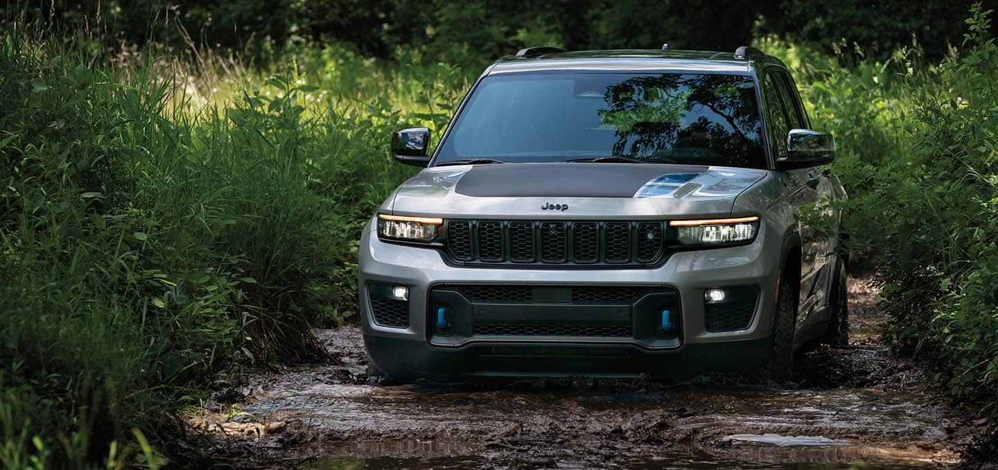 2025 Jeep Grand Cherokee Trail Hawk 4XE driving thick muddy stream