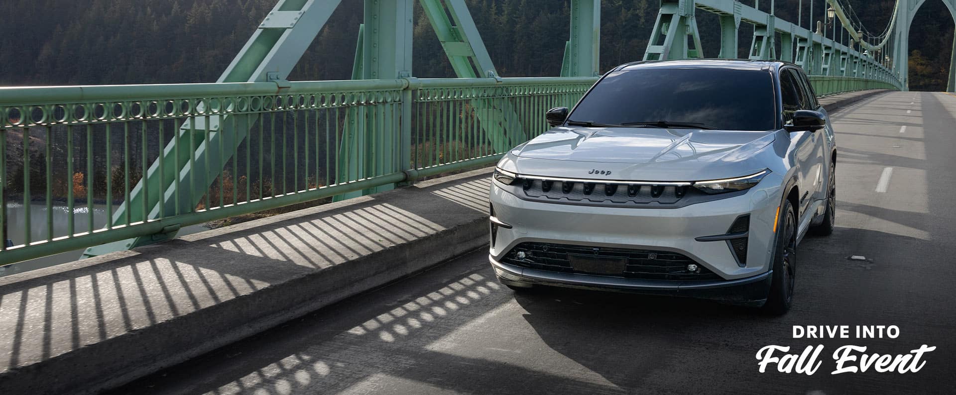 A white 2025 Jeep Wagoneer S Launch Edition traveling across a bridge. Drive Into Fall Event.