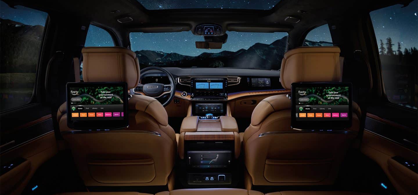 Display The second row of the 2025 Jeep Grand Wagoneer Series 3 with the two front seatback-mounted touchscreens displaying Amazon Fire TV selections.