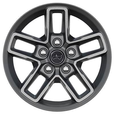 A wheel and tire on a blue 2026 Jeep Gladiator with seven other wheel designs selectable.