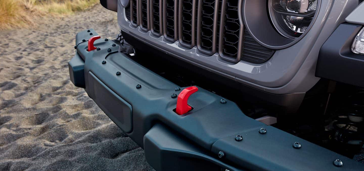 Display The red tow hooks on the front of a 2026 Jeep Gladiator Rubicon X.