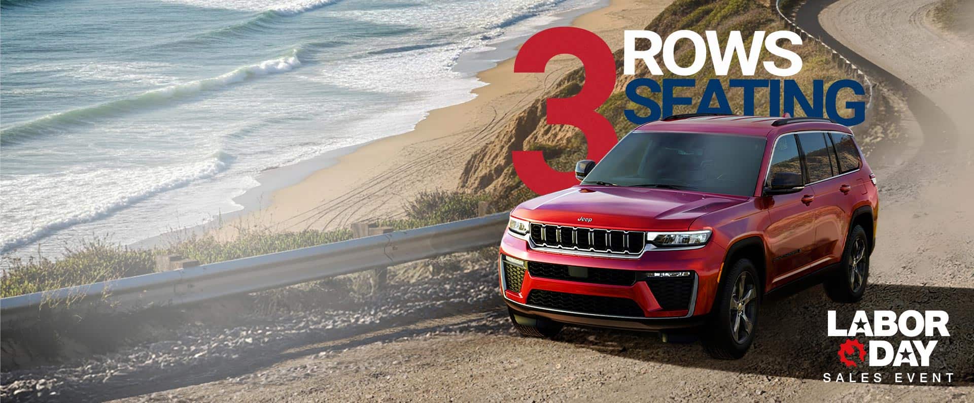 A red 2026 Jeep Grand Cherokee L Limited traveling on a beachfront road near the shoreline. Three rows of Seating. Labor Day Sales Event.
