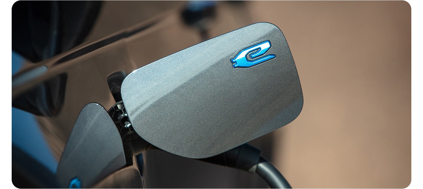 The charging port on the 2026 Jeep Grand Cherokee 4xe with a charging cord plugged in.