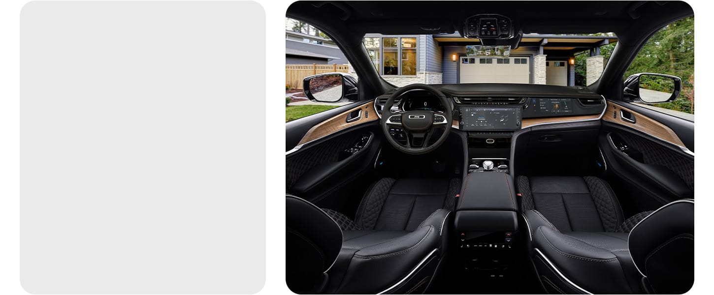 The interior of a 2026 Jeep Grand Cherokee Summit focusing on the front seats, steering wheel, Uconnect touchscreen, Front Passenger Interactive Display and center console controls.
