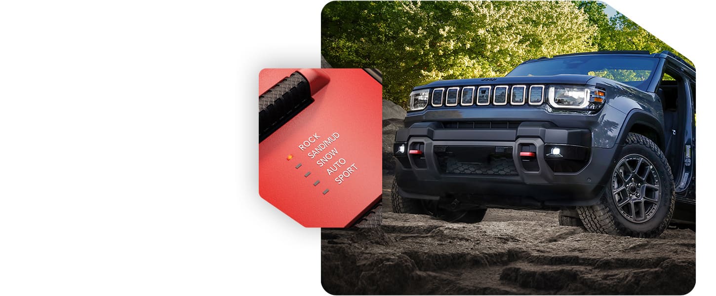 A gray 2026 Jeep Recon Moab with its doors removed, scaling a rocky trail off-road and the Selec-Terrain Traction Management System drive mode set on Rock.