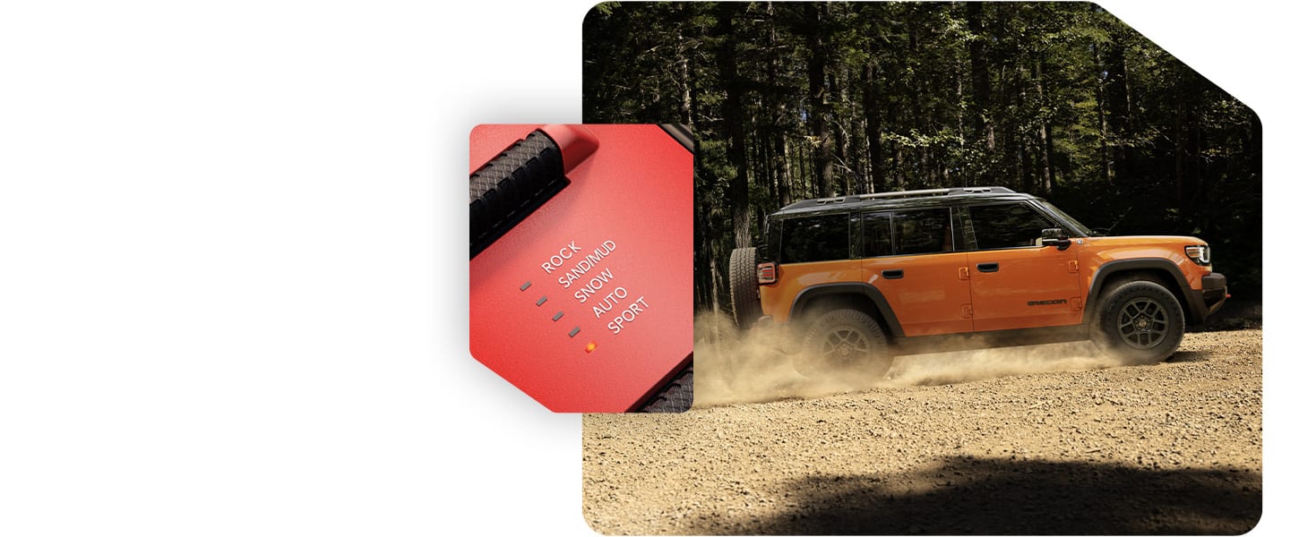 An orange 2026 Jeep Recon Moab traveling up a gently sloping sand hill and the Selec-Terrain Traction Management System drive mode set on Sport.