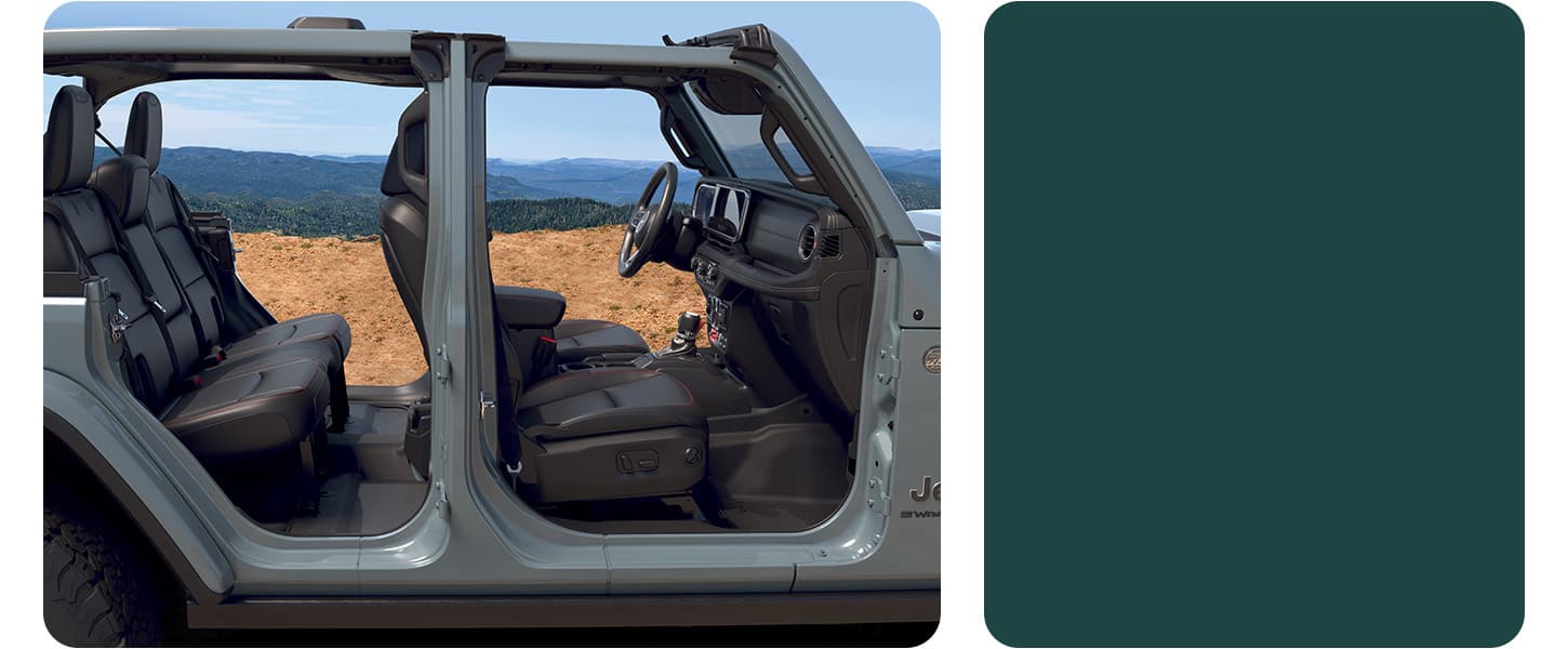 A gray 2026 Jeep Wrangler Rubicon X four-door, with its doors removed, so you can see through the vehicle and beyond.