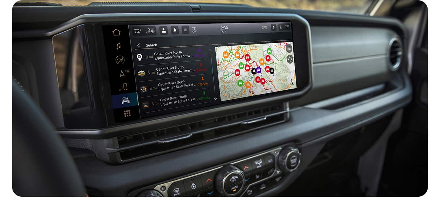 The Uconnect touchscreen in a 2026 Jeep Wrangler displaying a page in the Off-Road Trail Guide from Trails Offroad.