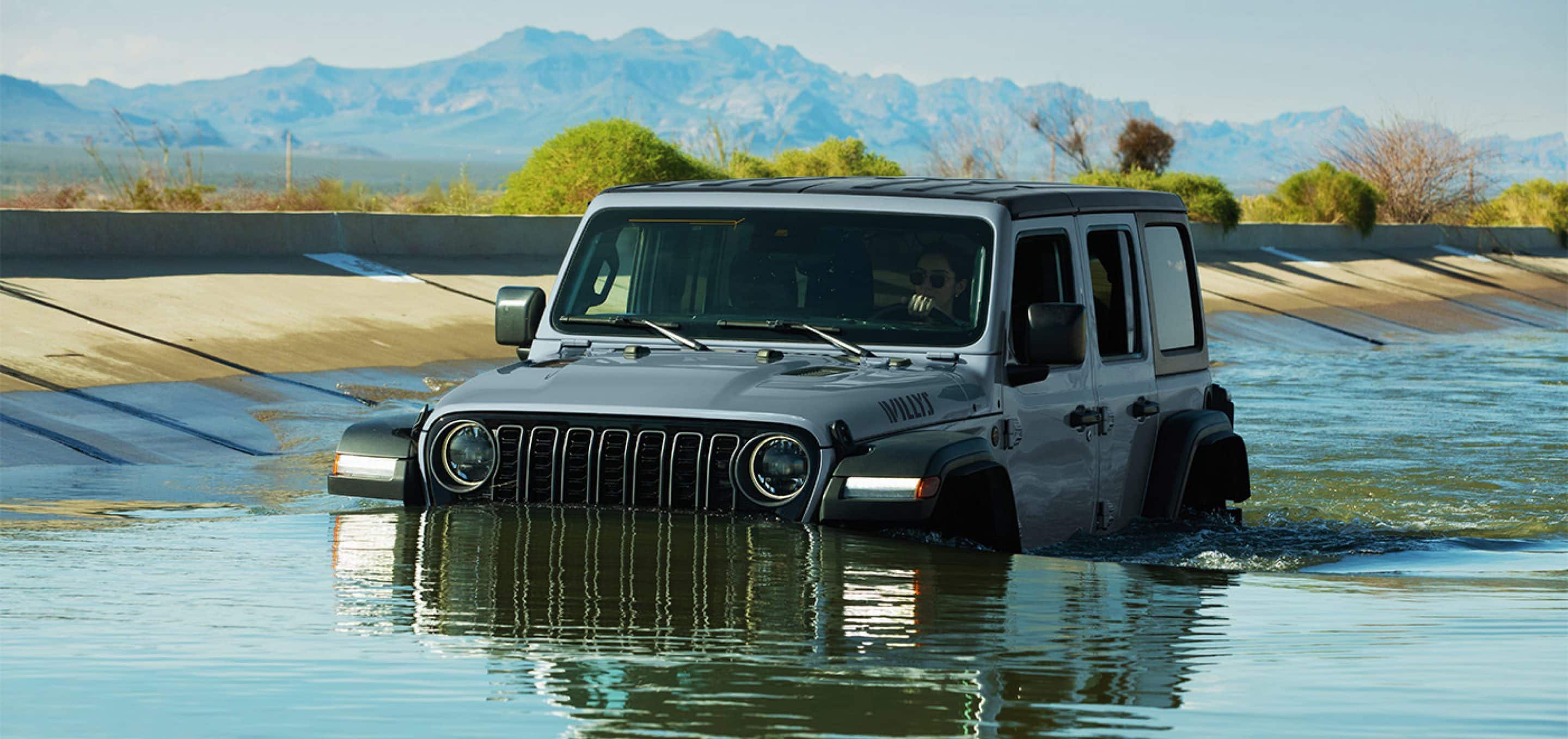 Jeep Wrangler parked at a trailhead ready to tow