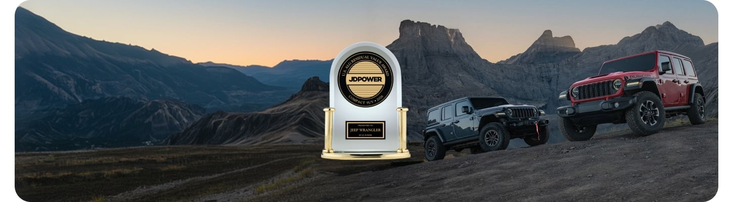Two 2026 Jeep Wrangler four-door models on a hill off-road in the mountains. On the left a blue Wrangler Rubicon and on the right, a red Wrangler Rubicon. Best Residual Value Among Compact SUVs in 2026. JD Power U.S. ALG Residual Value Award—Compact SUV 2026 Presented To Jeep Wrangler By JD Power.