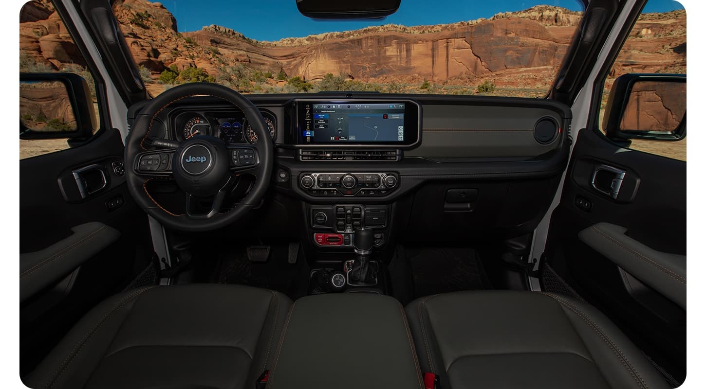 The dashboard of a 2027 Jeep Gladiator with mountains visible through the windshield.