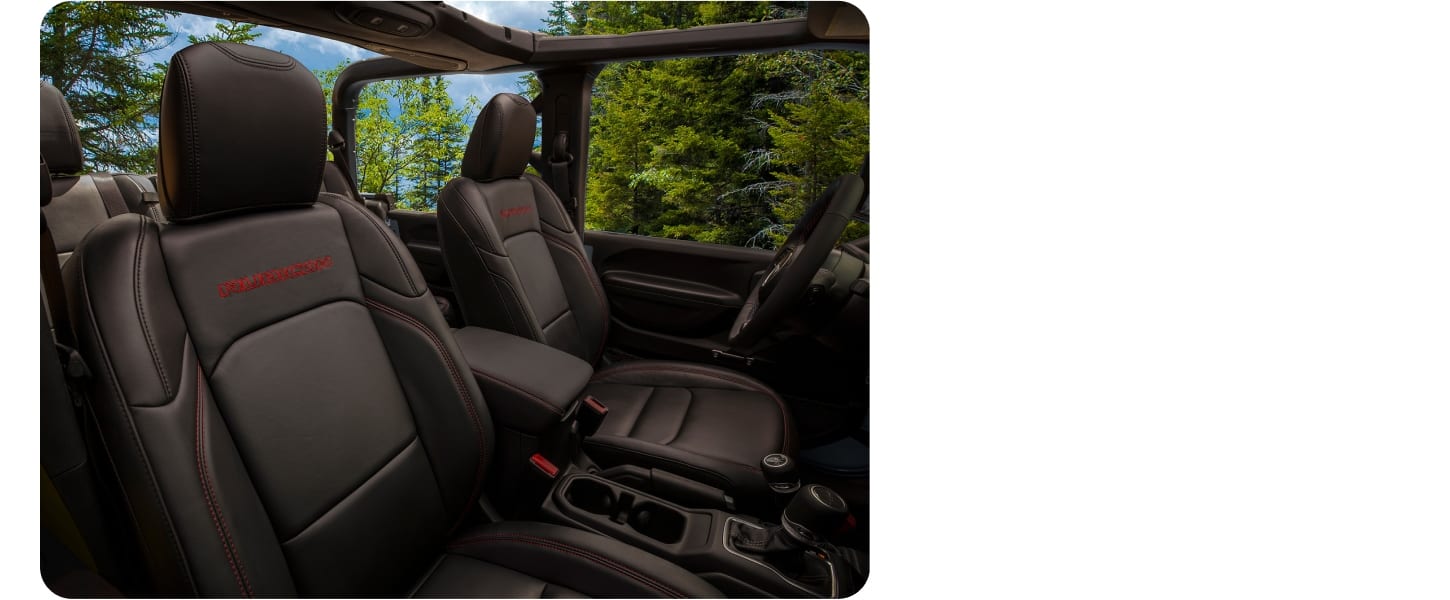 The front seats of a 2027 Jeep Gladiator Rubicon with its top off.