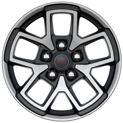 A close-up shot of a 17-Inch machined painted black wheel on a 2027 Jeep Gladiator Rubicon X.
