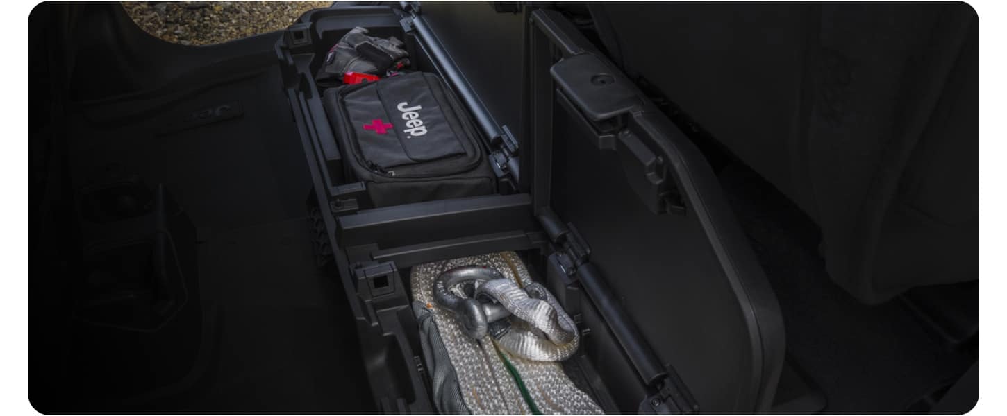 The available lockable rear-seat storage bin of a 2027 Jeep Gladiator.