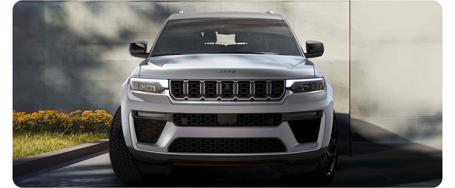 A head-on angle of a silver 2027 Jeep Grand Cherokee Summit.