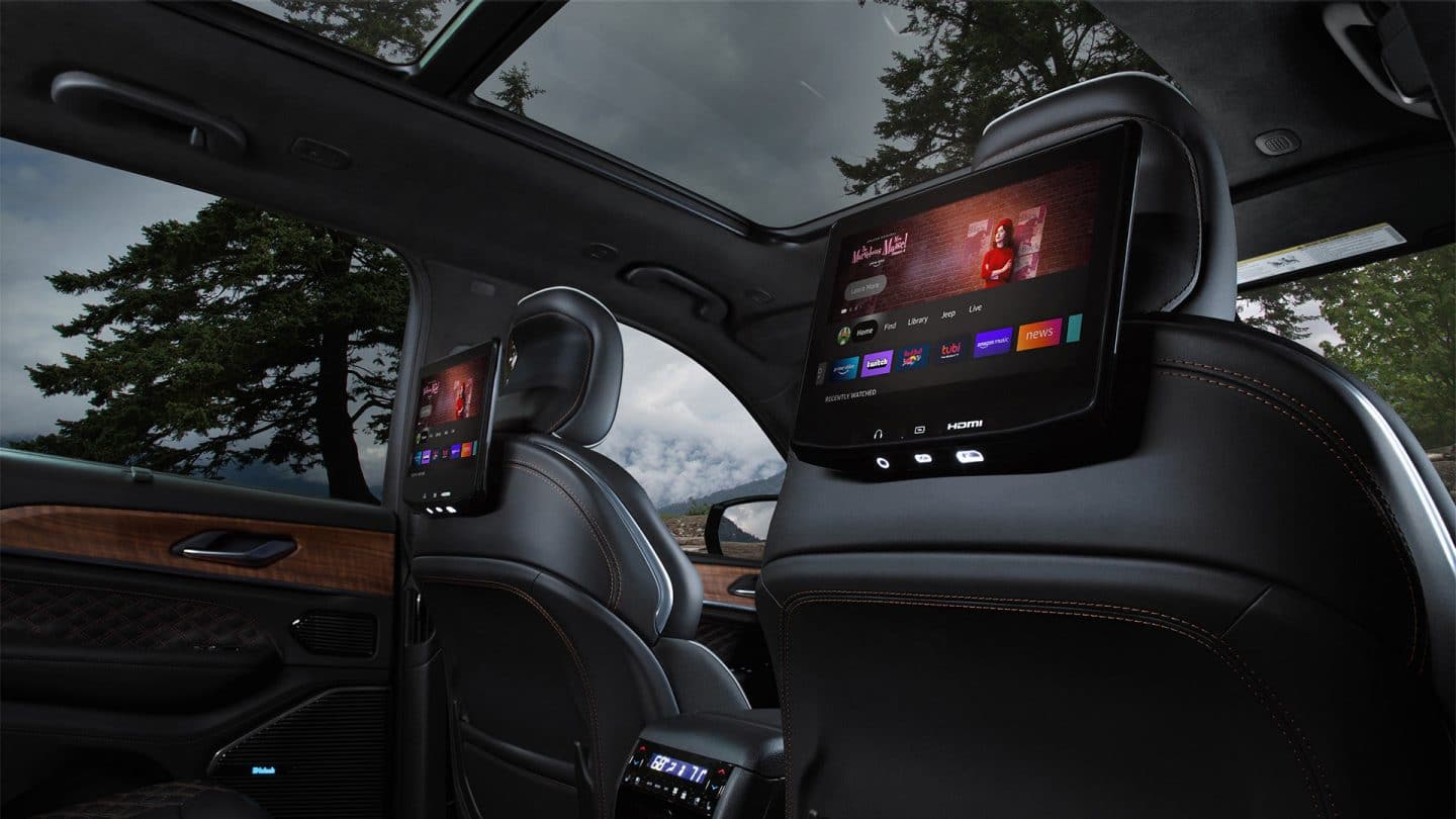 The seatback-mounted touchscreens in the second row of the 2027 Jeep Grand Cherokee Summit displaying Amazon Fire TV selections.