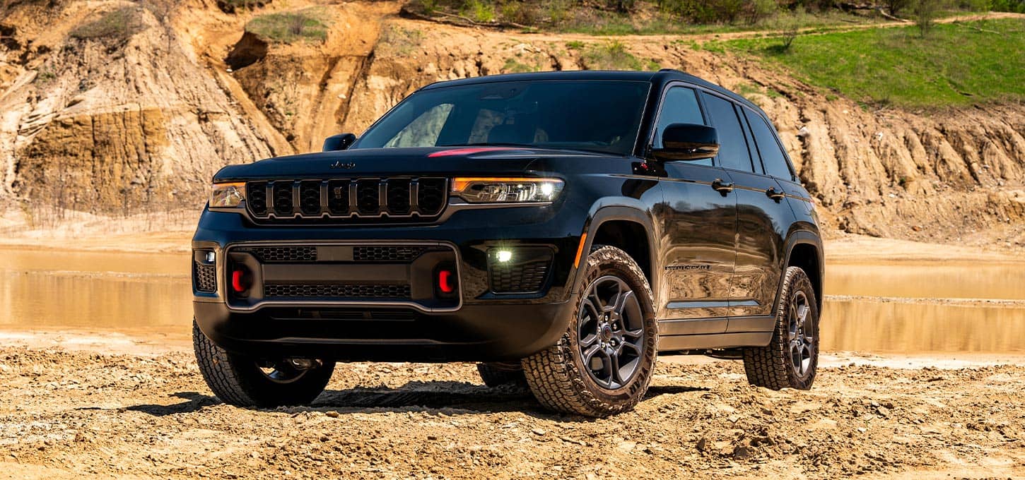Black Jeep Grand Cherokee on a dirt trail