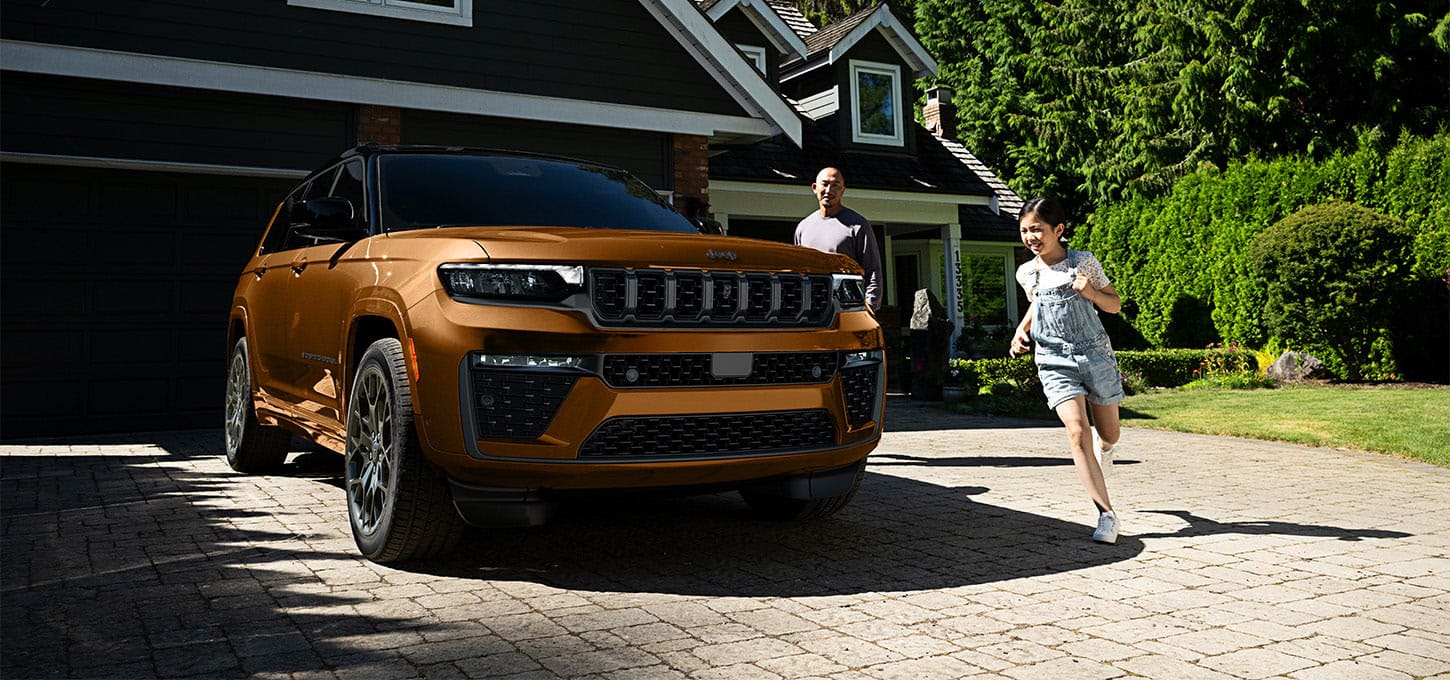 Copper Jeep Grand Cherokee parked in a driveway