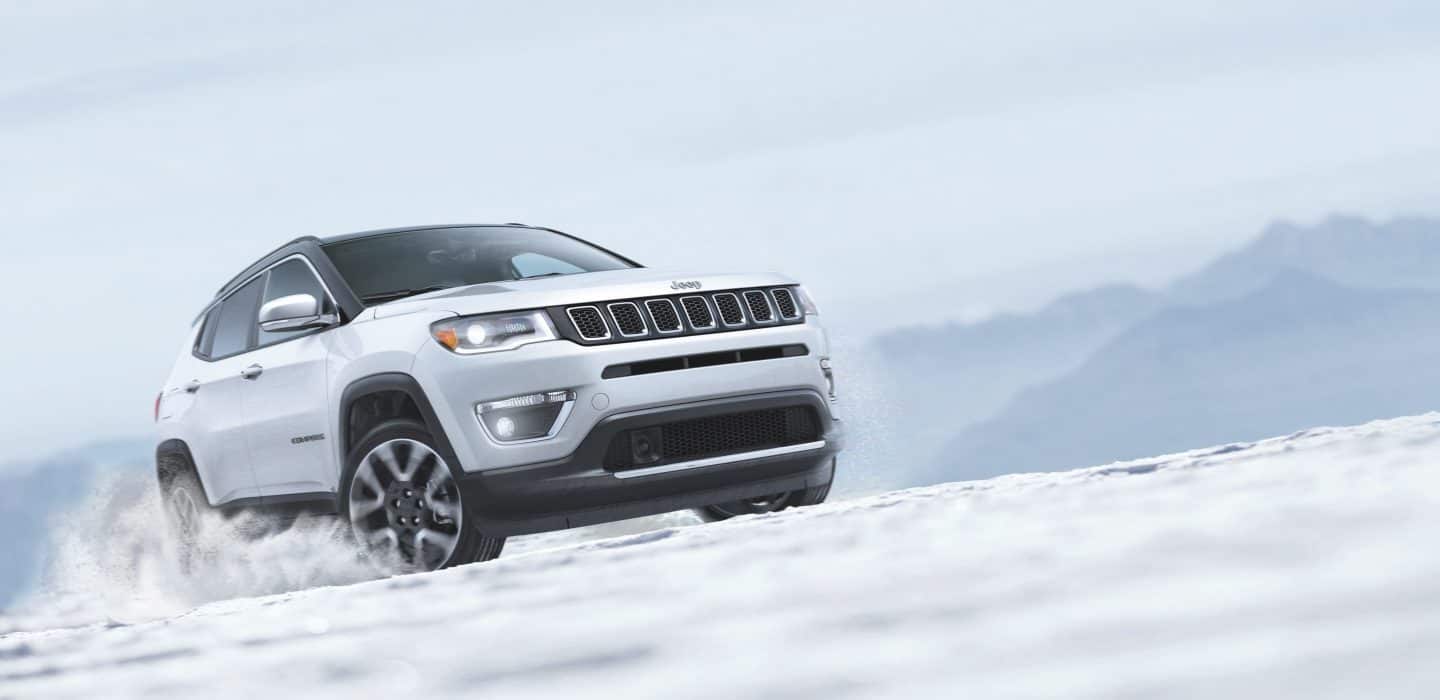 Jeep Compass being driven on the snow.