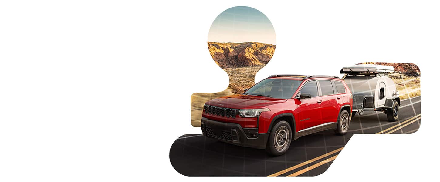 A red 2026 Jeep Cherokee Limited towing a compact travel trailer down a highway.