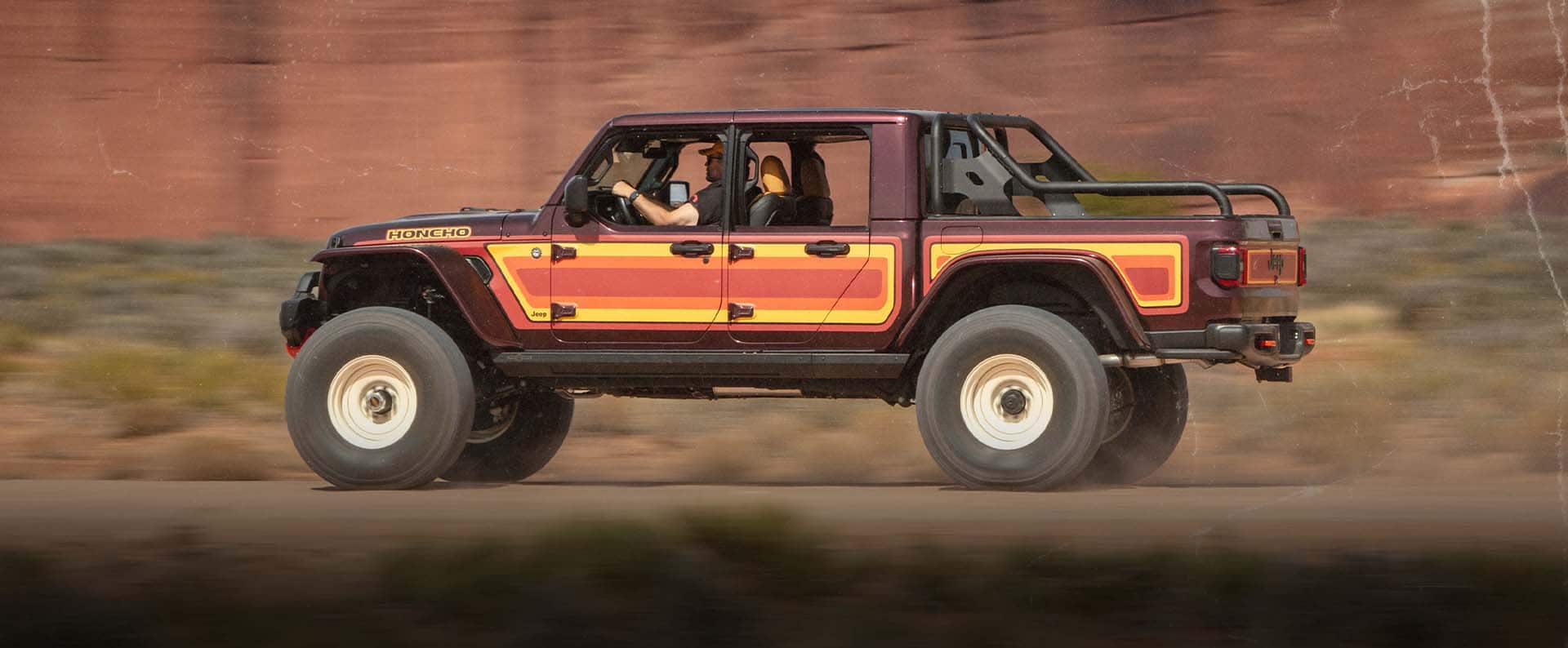 A driver-side profile of a 2025 Jeep Gladiator High Top Honcho Concept vehicle in shades of yellow, orange and red.