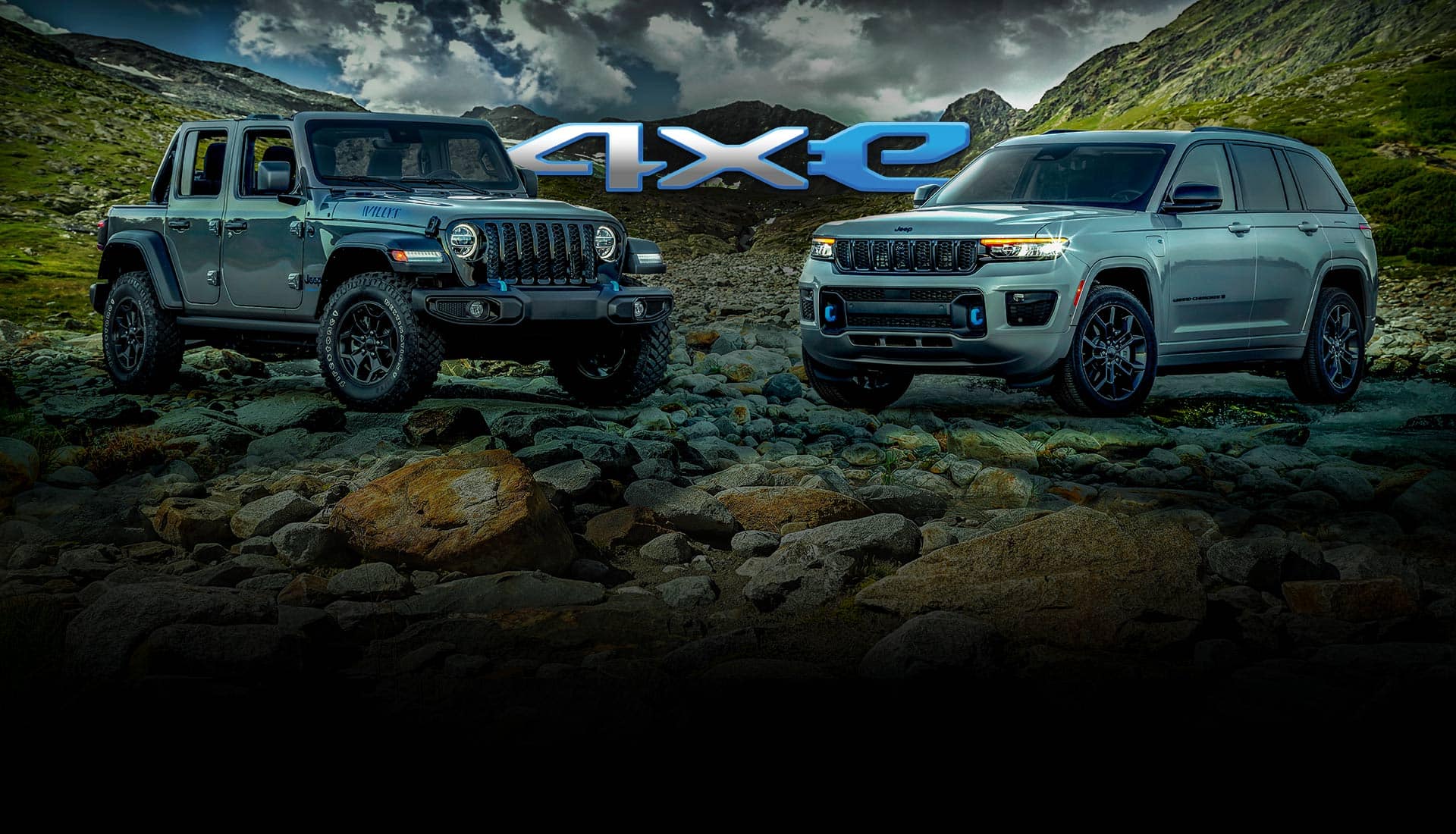 4xe. A 2023 Jeep Wrangler Willys 4xe and 2023 Jeep Grand Cherokee 30th Anniversary Edition 4xe parked on a rocky ridge with mountains and a stormy sky in the background.