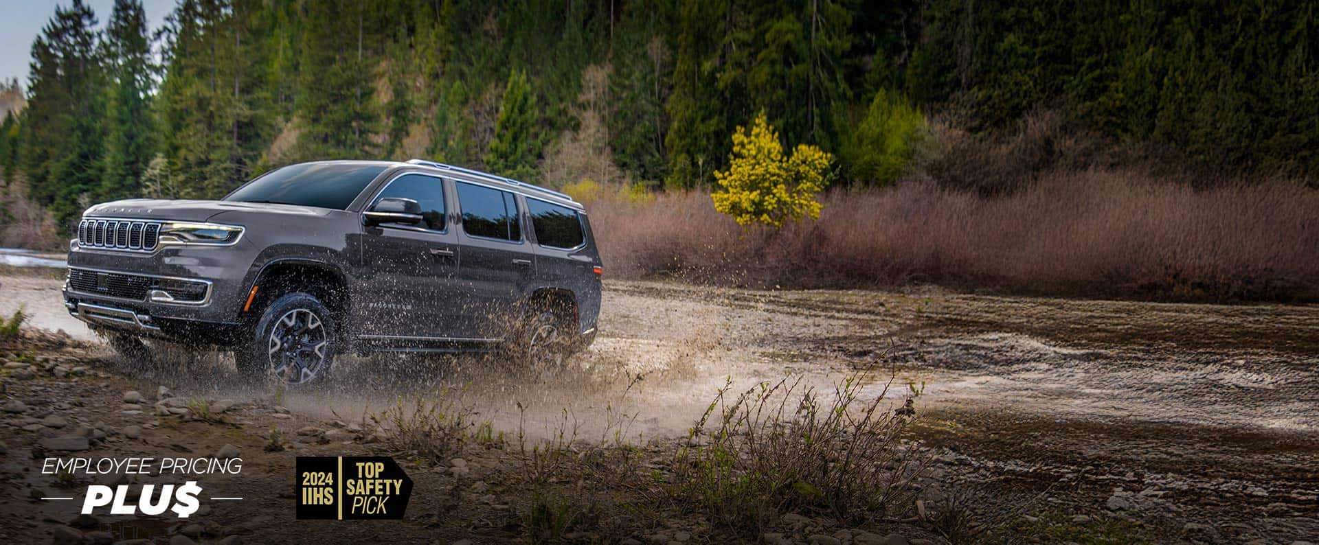 A grey 2024 Grand Wagoneer  L Series 3 exiting a muddy stream off-road. Employee pricing plus event.