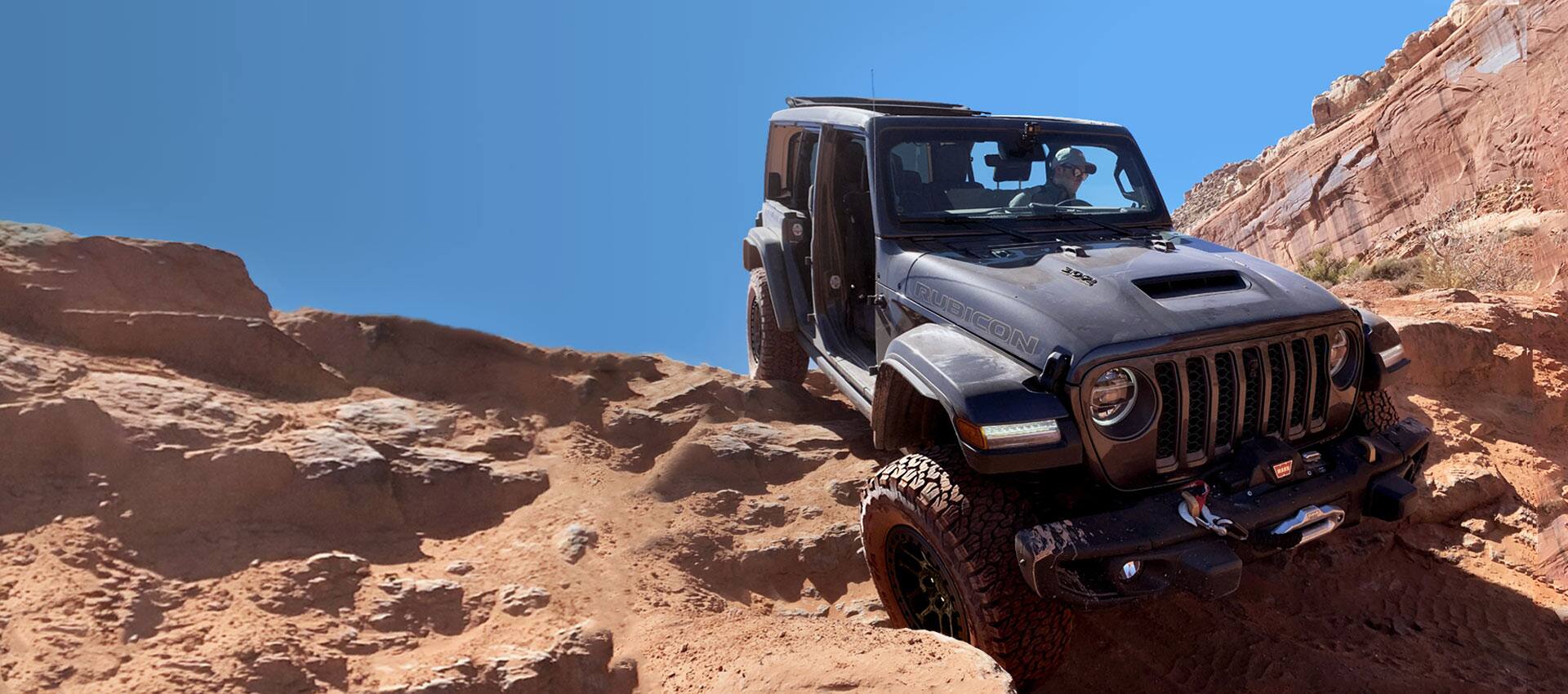 A 2021 Jeep Wrangler Rubicon with the Xtreme Recon Package descending an intense, steep rocky hill.