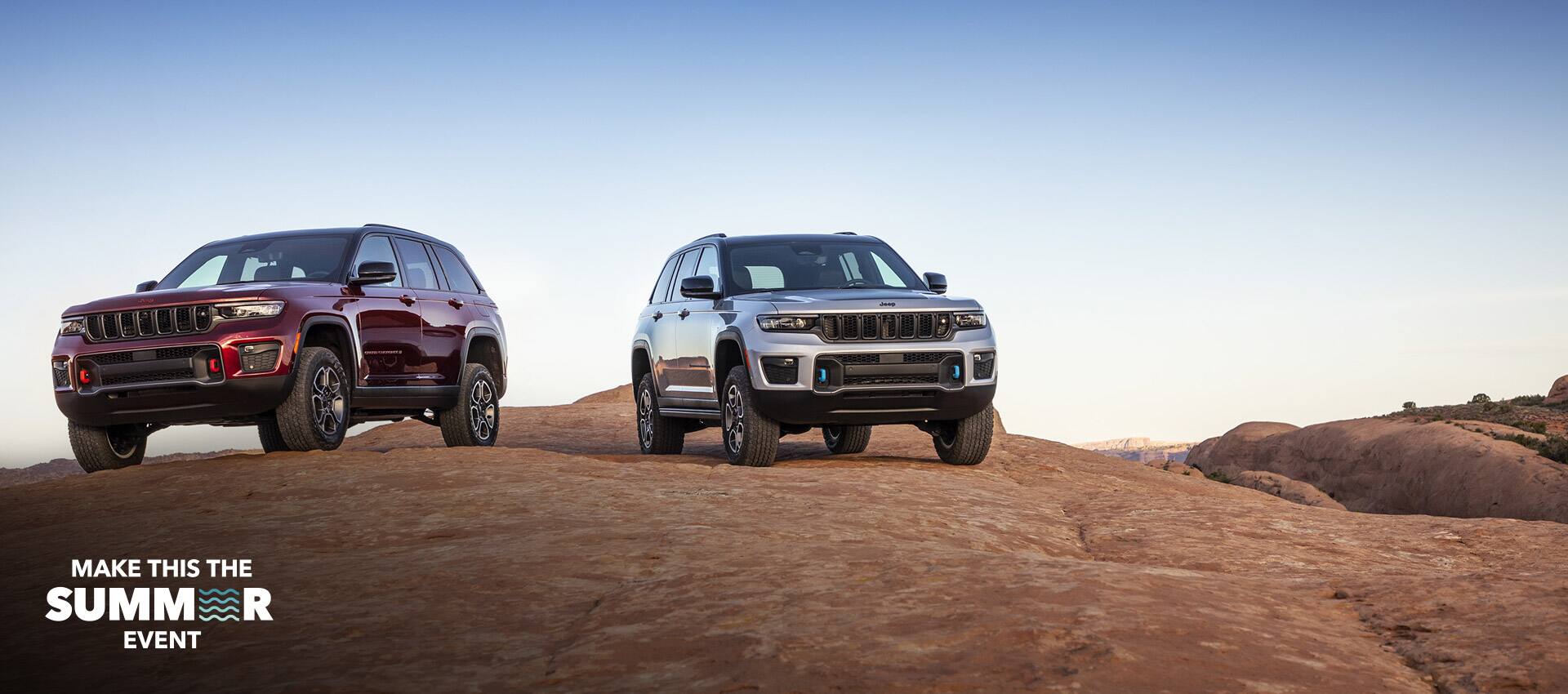 A 2022 Jeep Grand Cherokee Trailhawk and Trailhawk 4xe parked on a rocky plateau. The Make This The Summer Event logo.